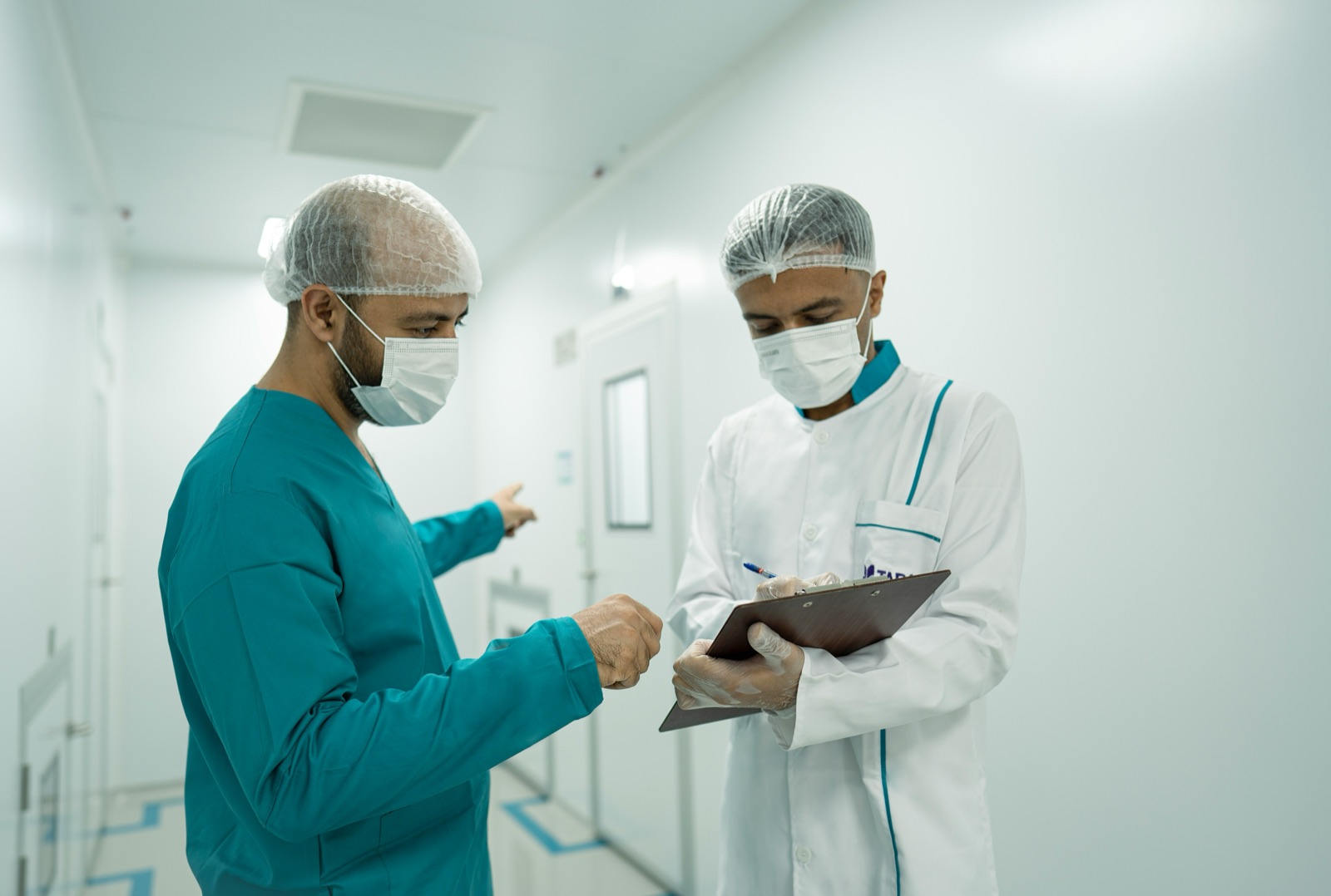 Two hospital doctors discussing a patient’s notes