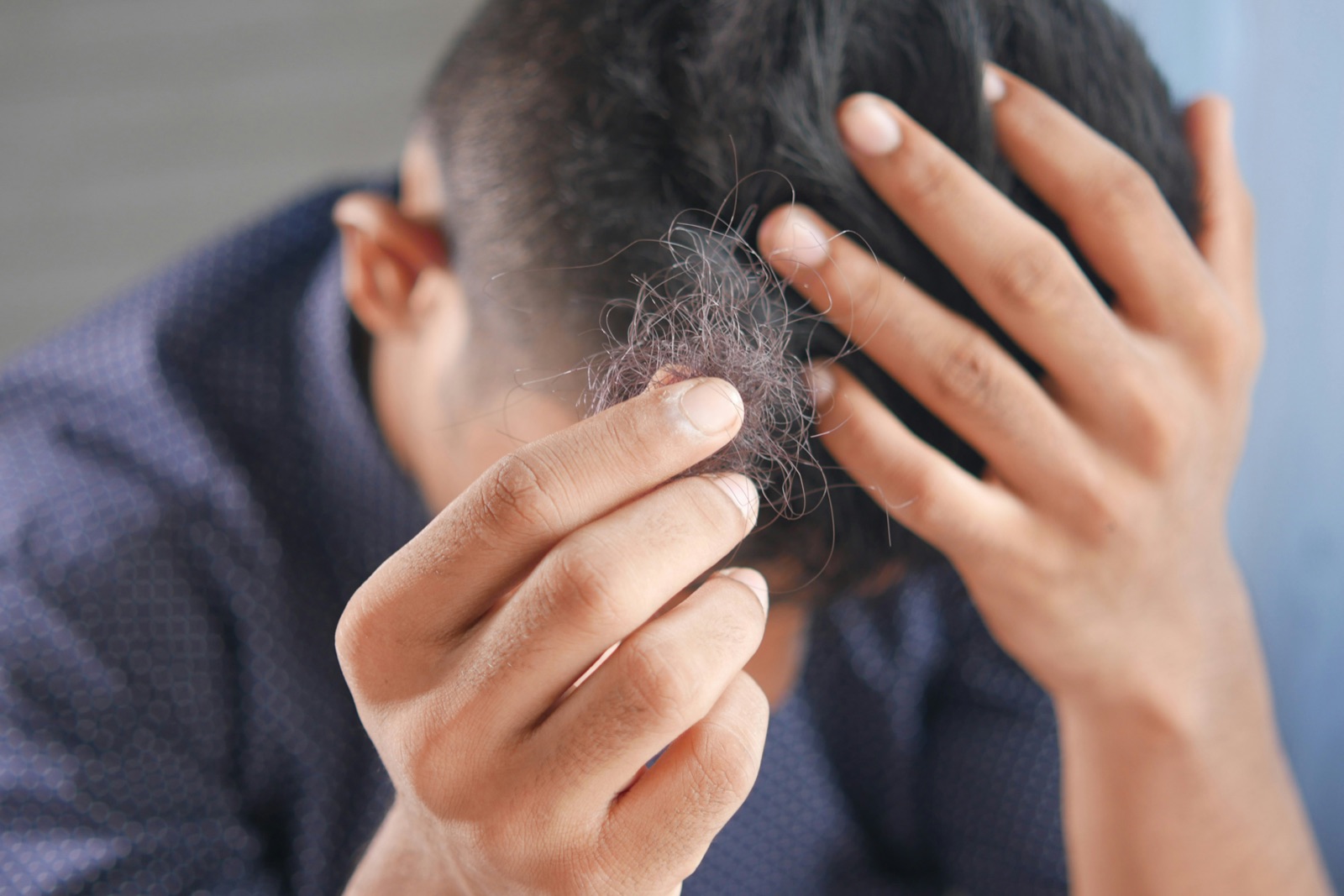A man running his hands through his hair