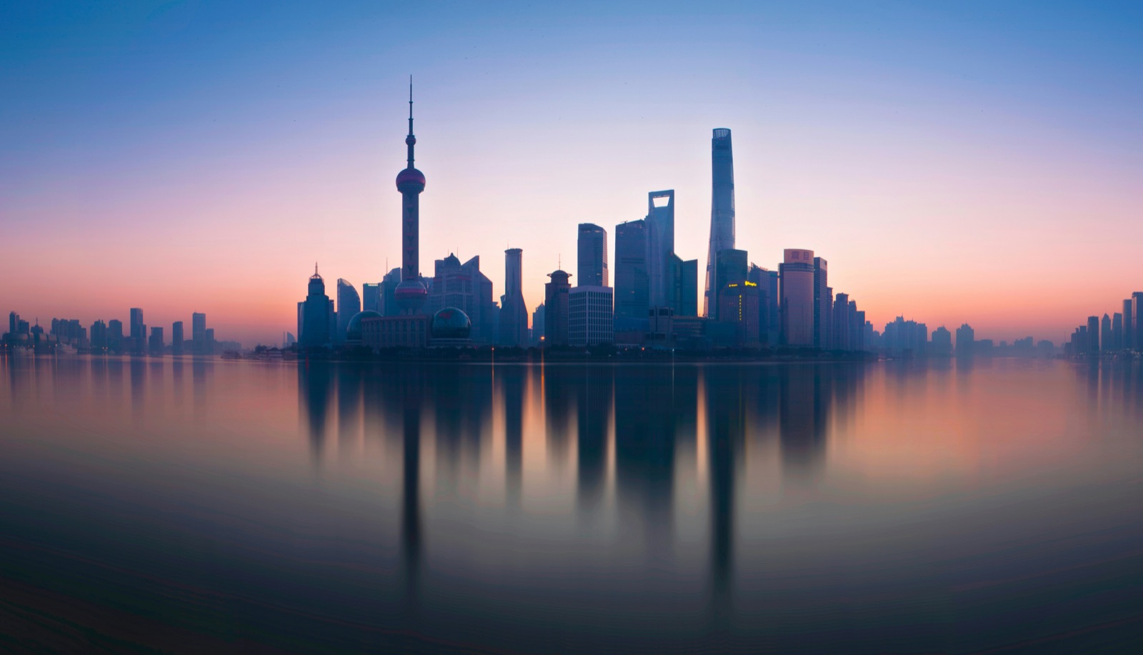 The Shanghai skyline across the Huangpu River at dusk